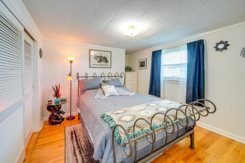a bedroom with a bed in a room with blue curtains at 4 Mi to Off-Road Park Beckley Area Townhome 