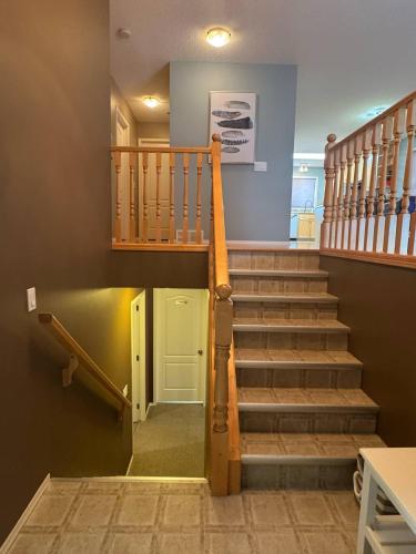a staircase in a house with a stair case at Heavenly Cozy Place Inc in Airdrie