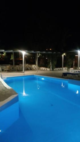 a large blue swimming pool at night at Cavo Christo in Petra