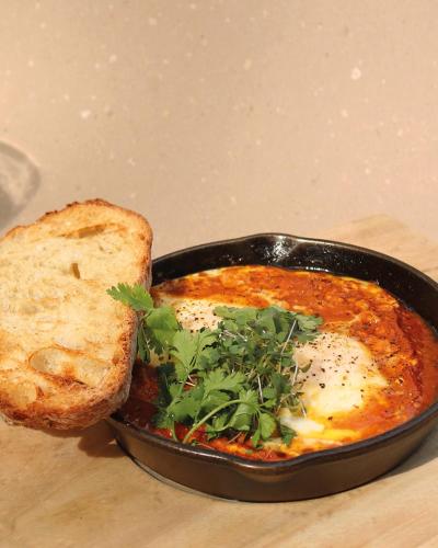a pan of food with a slice of bread at Il Buongustaio in San Salvador
