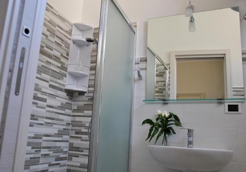 a bathroom with a sink and a mirror at Taorminaxos wonderful seaview in Giardini Naxos