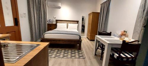a small room with a bed and a desk at Studio Apartment in Collingwood Park