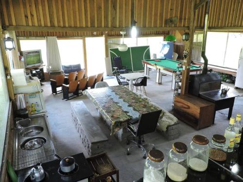 a living room with a table and a ping pong table at Pousada Sítio Paremi in Caxias do Sul