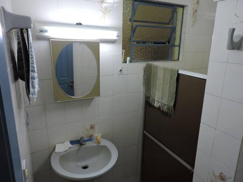 a small bathroom with a sink and a mirror at Pousada Sítio Paremi in Caxias do Sul