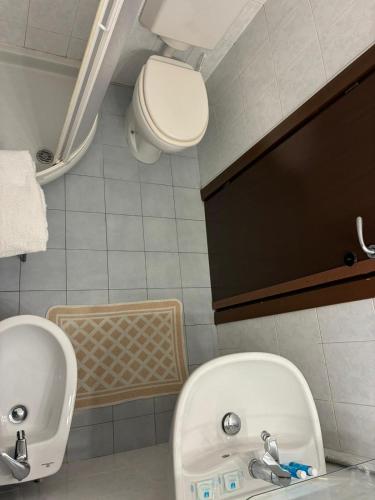 a bathroom with a toilet and a sink at Hotel Annunziata in Massa