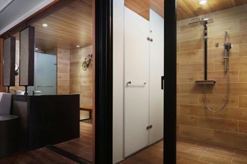 a bathroom with a shower and a sink at The Westin Yilan Resort in Yuanshan