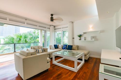 a living room with a couch and a table at Le Azul - 3BR Beachfront HOME in Laguna & Layan Beach next KORA Resort in Phuket