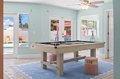 a pool table in a living room with a ceiling fan at Cozy 3BD ‘Sweet Memories’ | Pool, Games & Hot Tub in Cedar Hammock