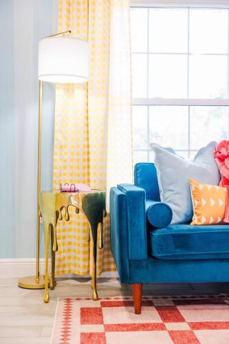 a blue couch in a living room with a lamp and a table at Cozy 3BD ‘Sweet Memories’ | Pool, Games & Hot Tub in Cedar Hammock