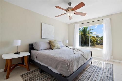 a bedroom with a bed and a ceiling fan at Splash Oasis, 4BR, 2BA Heated Pool, BBQ in Port Saint Lucie