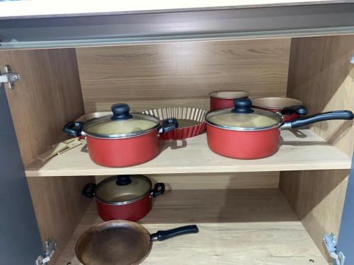 a group of pots and pans sitting on a shelf at Loft ZN Natal próx Norte Shopping Genipabu in Natal