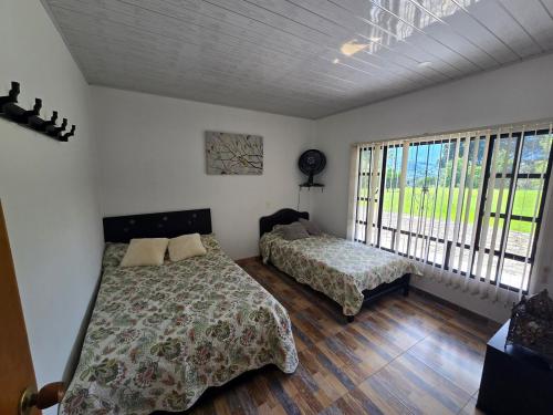 Postel nebo postele na pokoji v ubytování Villa Claudia, La Mesa, Cundinamarca