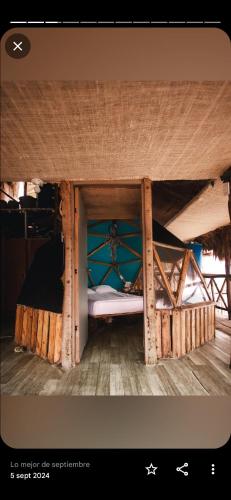 a small bed in a wooden bunk bed room at Hostal Ananda in Playa Blanca