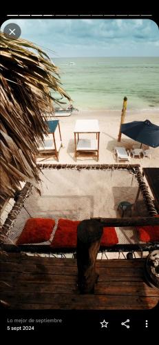 a view of a beach with a table and chairs at Hostal Ananda in Playa Blanca