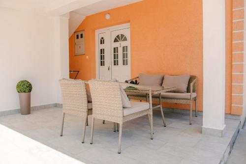 a patio with a table and wicker chairs at Apartments with parking space Lipovaca, Plitvice - 17657 in Rakovica