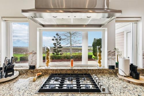 a kitchen with a stove top oven next to a window at New Skagit Tulip Farm Estate 3 beds 2 baths in Mount Vernon