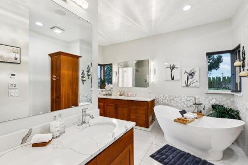 a bathroom with a large tub and a large mirror at New Skagit Tulip Farm Estate 3 beds 2 baths in Mount Vernon