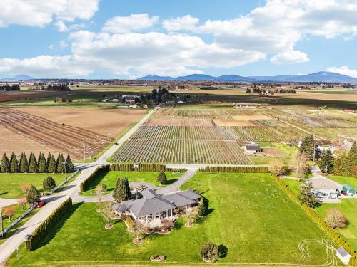 an aerial view of a farm with a house and a field at New Skagit Tulip Farm Estate 3 beds 2 baths in Mount Vernon