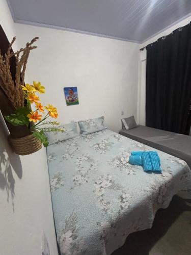 a small bedroom with a bed with blue sheets at São Jorge in Alto Paraíso de Goiás
