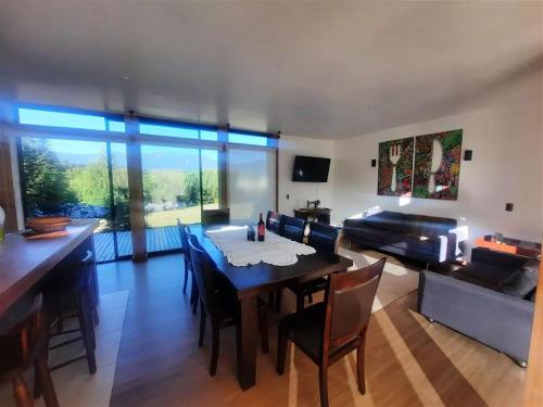 a living room with a table and a couch at Casa en San Andres Futrono in Futrono