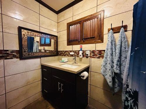 a bathroom with a sink and a mirror at Cozy & Spacious 3BR Rustic Stay Minutes from LAX in Compton