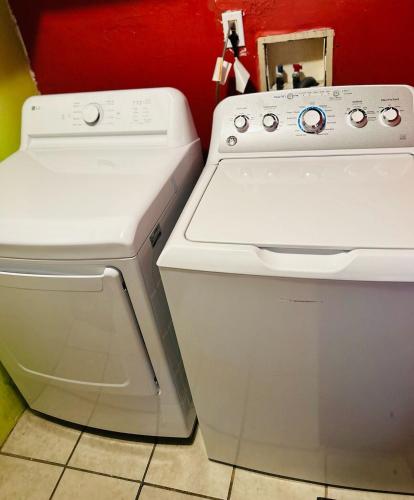a white stove and oven next to a red wall at Cozy & Spacious 3BR Rustic Stay Minutes from LAX in Compton