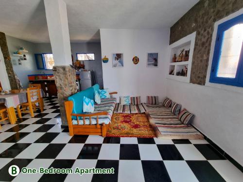 a living room with a couch and a checkered floor at dar zaiouane in Berga