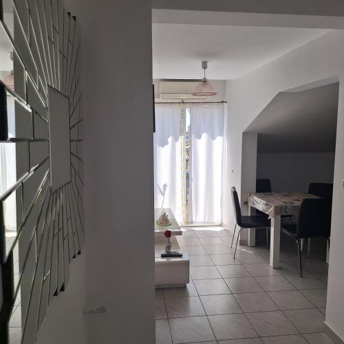 a living room with a table and a dining room at Apartments Villa Excellente Belvedere in Pula