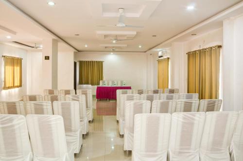 a room filled with white chairs and a table at The Park Classic Udaipur in Udaipur
