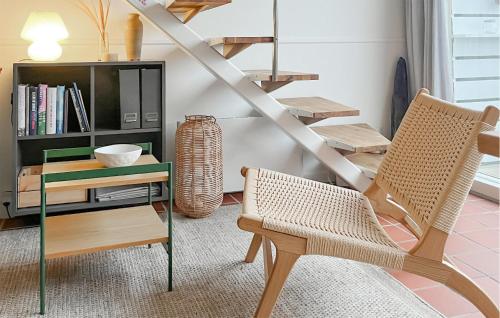 a living room with a chair and a table at 1 Bedroom Amazing Apartment In Fanø in Fanø