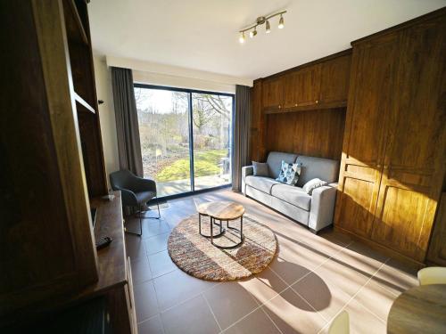 a living room with a couch and a table at Apartment in Durbuy near Ourthe River in Durbuy