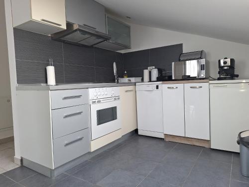 a kitchen with white appliances in a room at Apartments Villa Excellente Belvedere in Pula