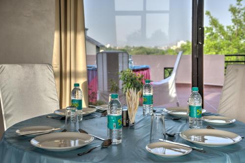 a blue table with plates and bottles of water at The Park Classic Udaipur in Udaipur