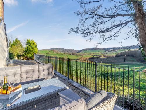 a patio with a table and a fence at The Lodge in Wonastow