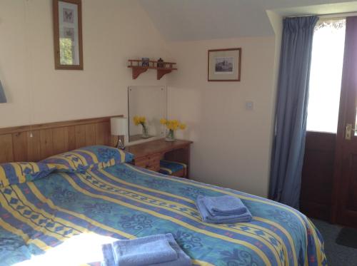 Katil atau katil-katil dalam bilik di Stable Cottages