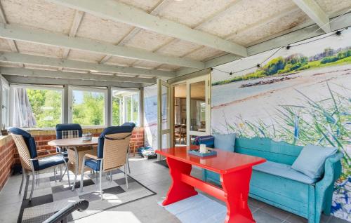 a living room with a blue couch and a table at 2 Bedroom Beautiful Home In Skjern in Skjern