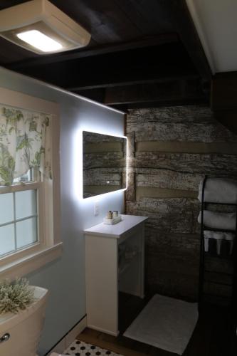 a bathroom with a sink and a brick wall at The Hutch in Bardstown