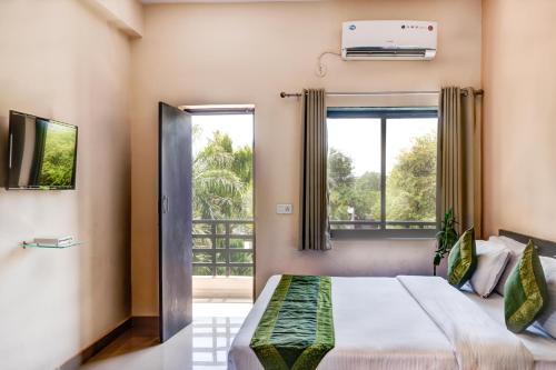 a bedroom with a bed and a window at The Park Classic Udaipur in Udaipur