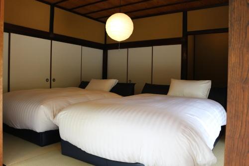 Ein Bett oder Betten in einem Zimmer der Unterkunft Takeda Base Inn