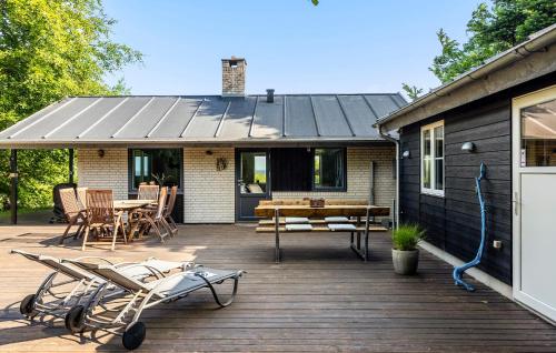 a deck with chairs and a table on a house at 3 Bedroom Amazing Home In Fur in Fur