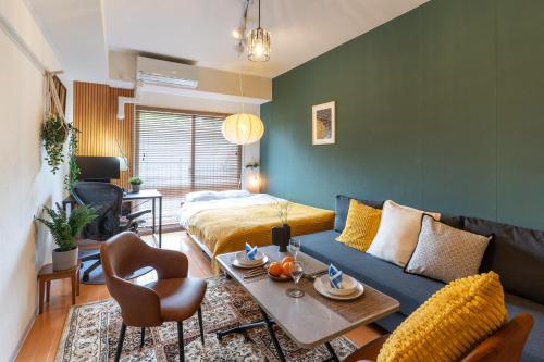 a living room with a couch and a table at Koubun Room Yokohama Hiyoshi Vacation Rental in Yokohama
