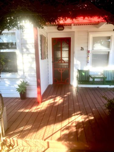 a front door of a white house with a red door at Hill Cottage in Clare