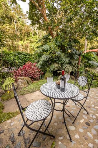 a table with a bottle of wine and two chairs at Ecohotel Piedemonte in Salento