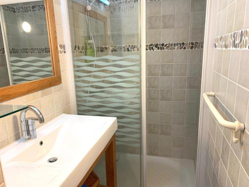 une salle de bain avec un lavabo et une douche dans l'établissement Charmante maison T2 avec piscine chauffée, tennis, proche mer, commerces, et WiFi inclus - FR-1-231-307, à Bretignolles-sur-Mer