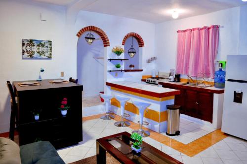 a living room with a kitchen with a stove at Queen GrandiaHouse in Puerto Vallarta