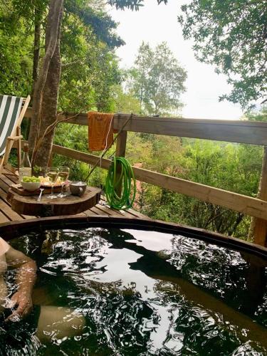 a pool of water in a yard with a wooden deck at Chalet con Tinaja LicanRay in Challupen