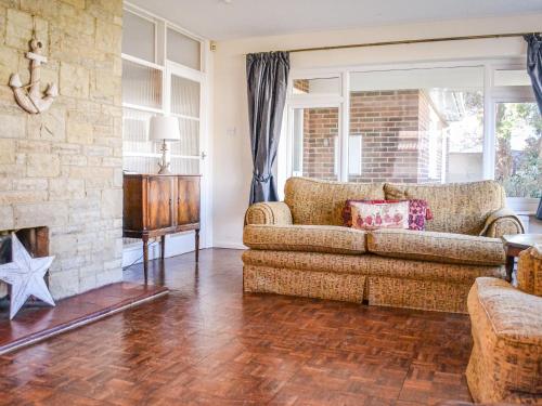 a living room with a couch and a fireplace at Botany Bay Bungalow in Kingsgate
