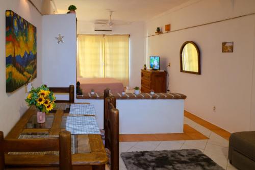 a living room with a table and a bed at Balcony GrandiaHouse in Puerto Vallarta