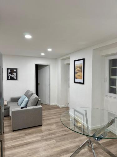 a living room with a couch and a glass table at Casa do Viriato in Guarda
