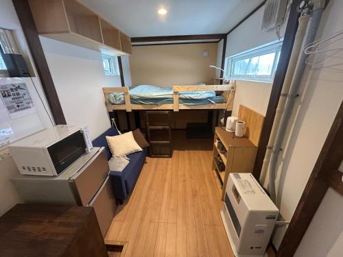 a small room with a bed and a desk at niseko kamahale village - Vacation STAY 91397v in Ōmagari